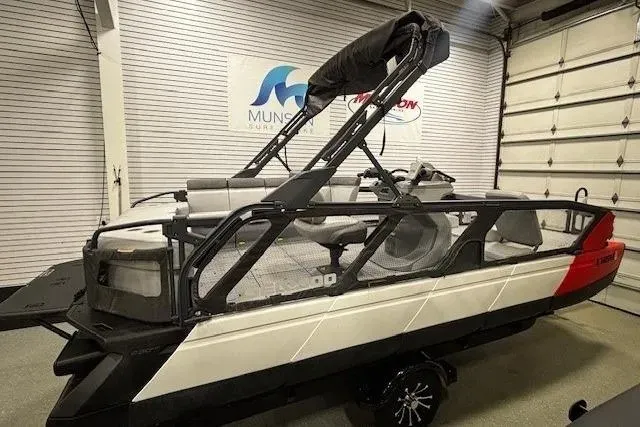 Slide: The Image of 2022 Sea-Doo Switch Cruise 21 pontoon boat in showroom, side view. - 1