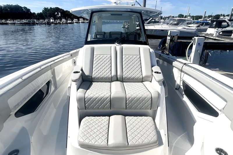 Slide: The Image of 2023 Pursuit S 378 Sport boat interior with luxurious seating at marina. - 14