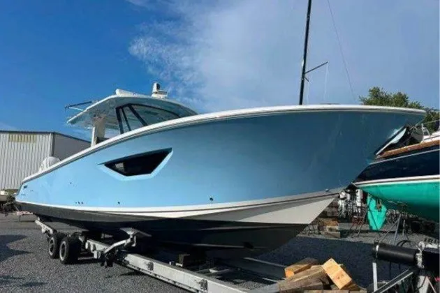 Slide: The Image of 2023 Pursuit S 378 Sport boat on trailer, light blue hull, outdoor setting. - 2