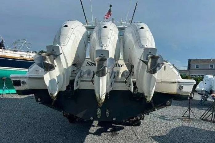 Slide: The Image of 2023 Pursuit S 378 Sport boat with triple outboard engines, rear view. - 11