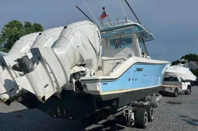 Slide: The Image of 2023 Pursuit S 378 Sport boat with triple Yamaha engines on a trailer. - 8