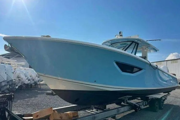 Slide: The Image of 2023 Pursuit S 378 Sport boat on trailer under clear blue sky. - 3