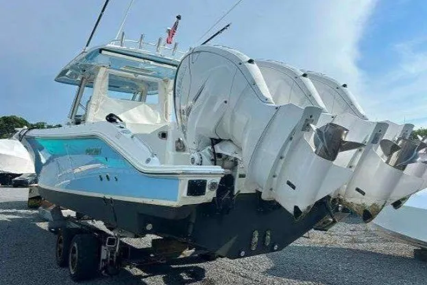 Slide: The Image of 2023 Pursuit S 378 Sport boat with triple outboard engines on a trailer. - 4