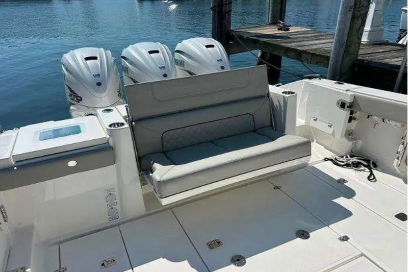 Slide: The Image of 2023 Pursuit S 378 Sport boat with triple engines and cushioned seating. - 12