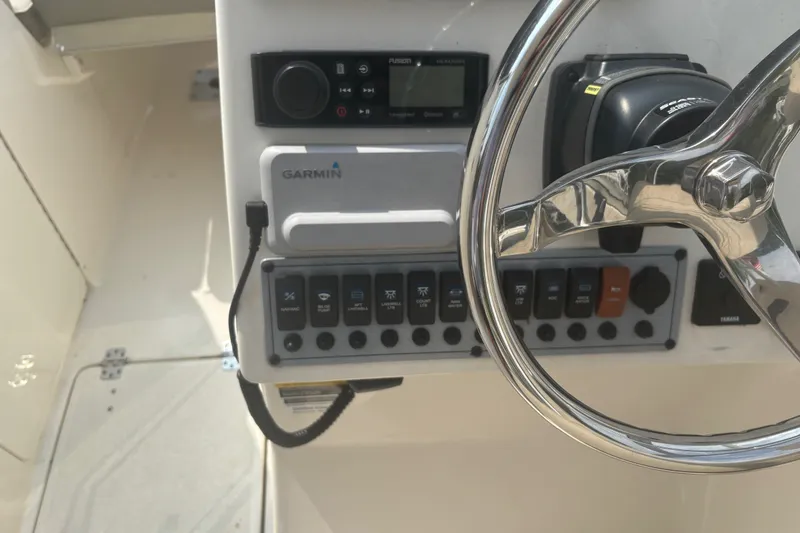 Slide: The Image of 2023 Key West 239 DFS boat dashboard with Garmin navigation and control panel. - 32