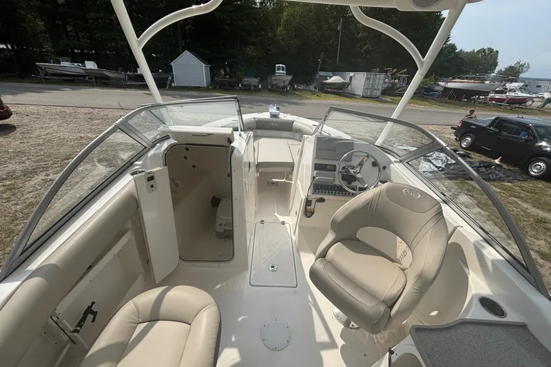 Slide: The Image of 2023 Key West 239 DFS boat interior with seating and steering console. - 24
