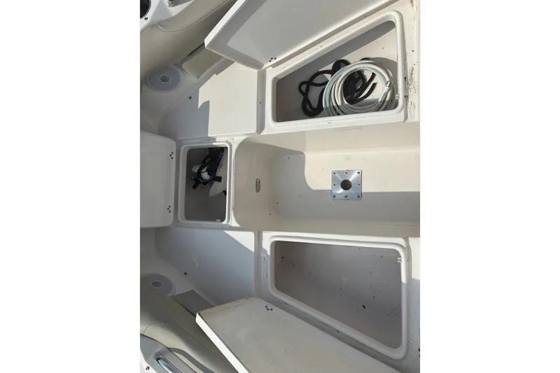 Slide: The Image of 2023 Key West 239 DFS boat storage compartments with ropes and equipment. - 47