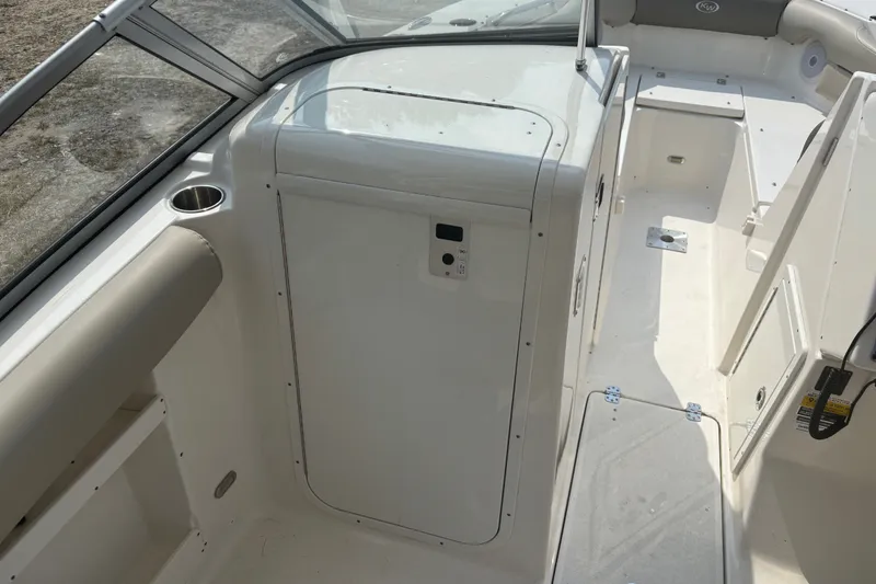 Slide: The Image of 2023 Key West 239 DFS boat interior with seating and storage compartments. - 53