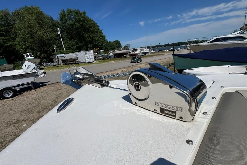 Slide: The Image of 2023 Key West 239 DFS boat with anchor winch, docked near other boats. - 10