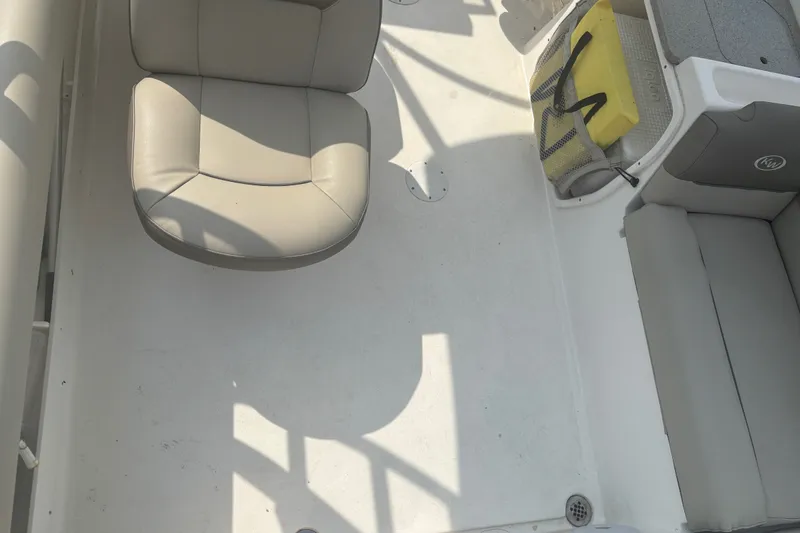 Slide: The Image of Interior of 2023 Key West 239 DFS boat with beige seating and storage area. - 19