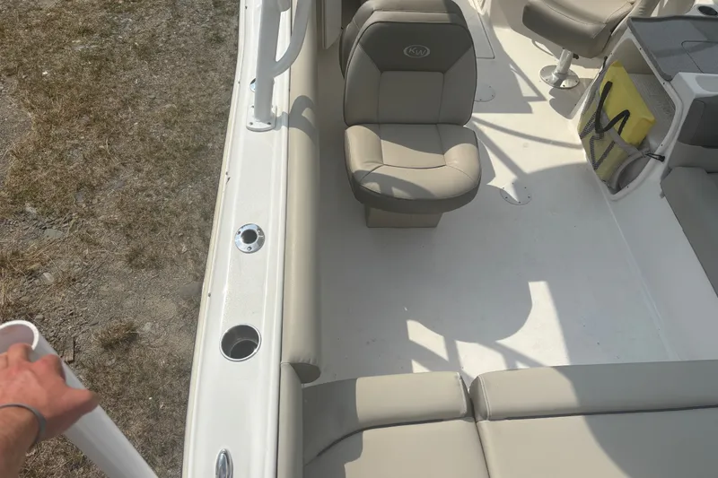 Slide: The Image of 2023 Key West 239 DFS boat interior with beige seating and storage compartments. - 18