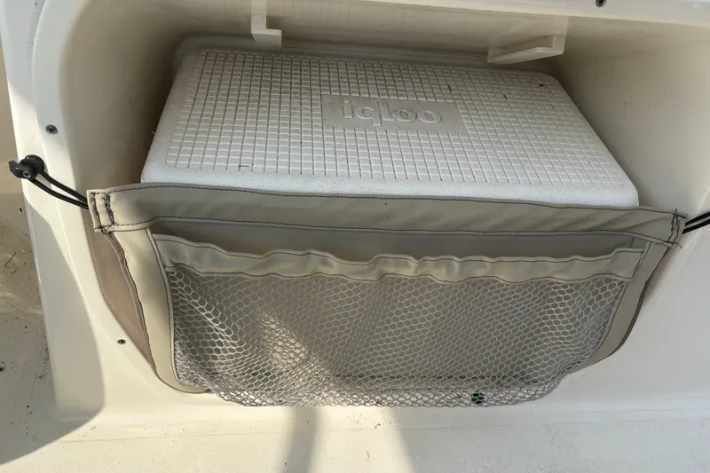 Slide: The Image of Storage compartment with Igloo cooler on 2023 Key West 239 DFS boat. - 54