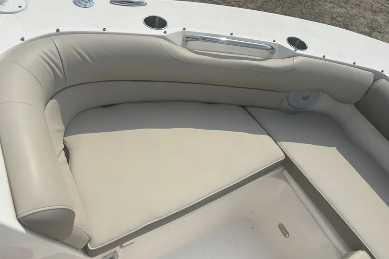 Slide: The Image of 2023 Key West 239 DFS boat interior with beige cushioned seating and cup holders. - 38