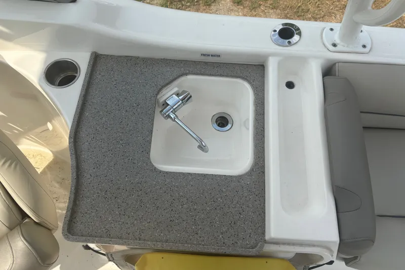 Slide: The Image of 2023 Key West 239 DFS boat sink with faucet and cup holders on deck. - 29