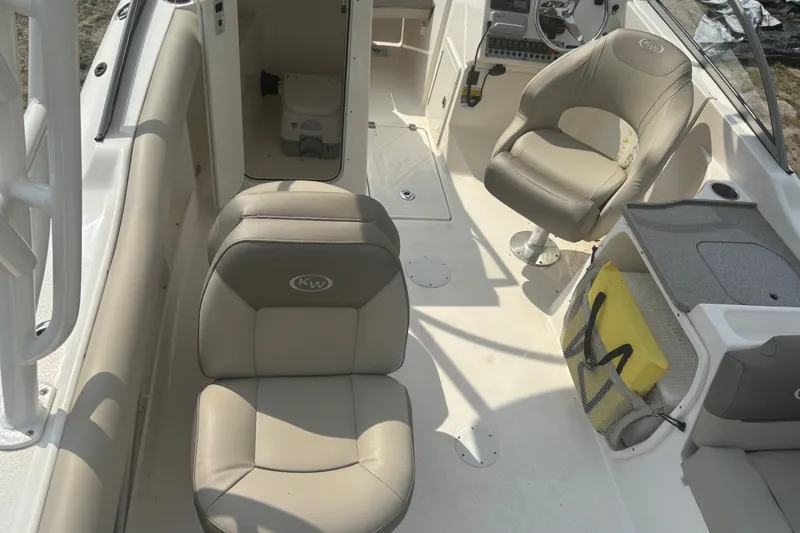 Slide: The Image of 2023 Key West 239 DFS boat interior with beige seating and steering console. - 20
