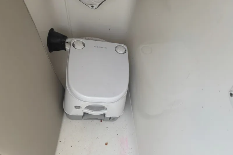 Slide: The Image of Portable toilet in a 2023 Key West 239 DFS boat interior. - 50