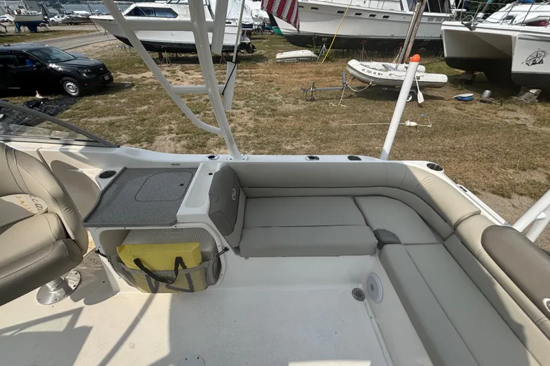 Slide: The Image of 2023 Key West 239 DFS boat interior with seating and storage, docked outdoors. - 25