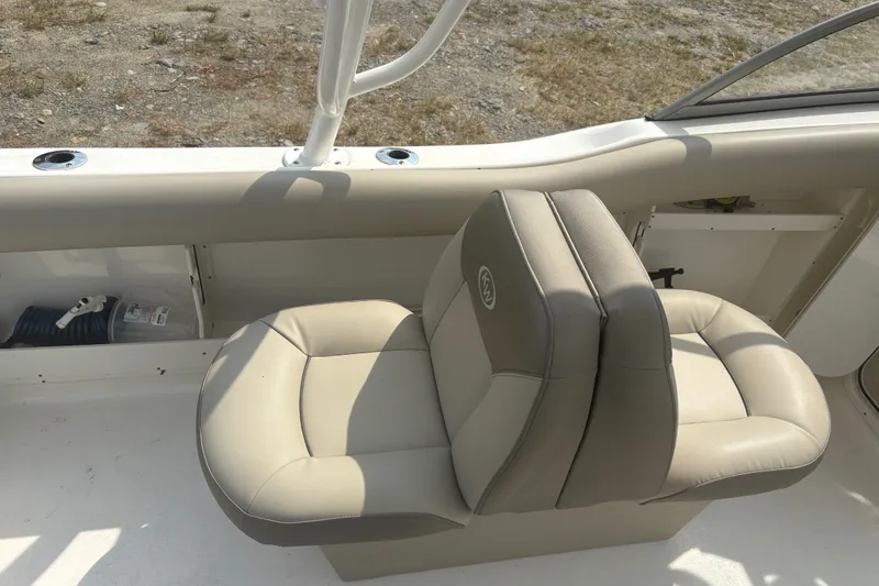 Slide: The Image of 2023 Key West 239 DFS boat seat with beige upholstery and storage compartment. - 22