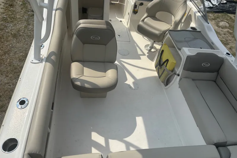 Slide: The Image of 2023 Key West 239 DFS boat interior with beige seating and spacious layout. - 17