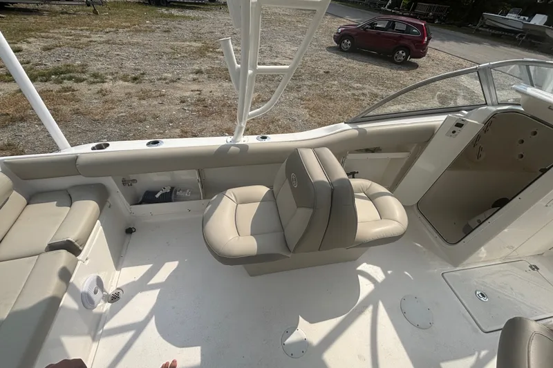 Slide: The Image of 2023 Key West 239 DFS boat interior with beige seating and open storage compartments. - 21