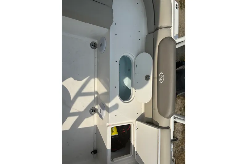 Slide: The Image of 2023 Key West 239 DFS boat interior with seating and storage compartments. - 40
