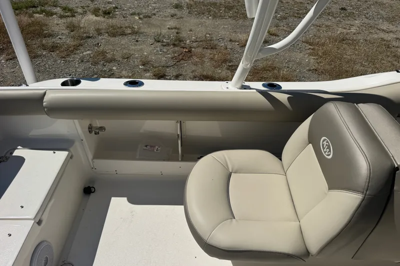 Slide: The Image of 2023 Key West 239 DFS boat interior with beige seating and cup holders. - 4