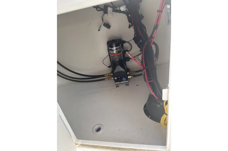 Slide: The Image of 2023 Key West 239 DFS boat compartment with SeaStar hydraulic pump and wiring. - 48