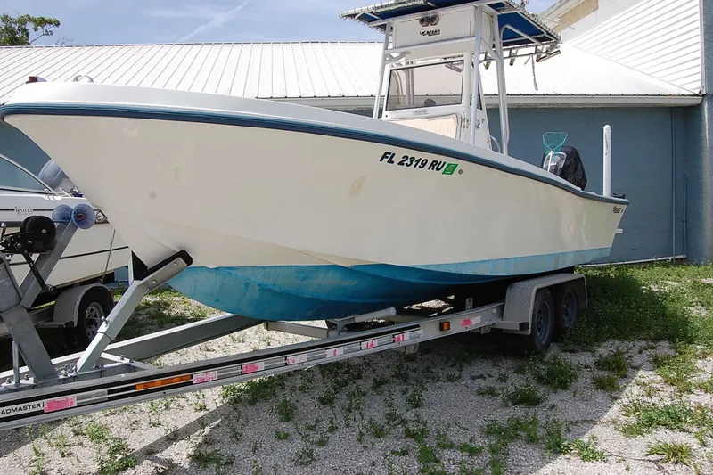 The Image of 1992 Mako 221 Center Console boat on trailer, parked outdoors. - 1