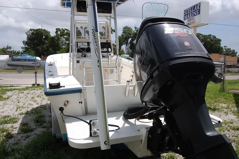 Slide: The Image of 1992 Mako 221 Center Console boat with powerful outboard motor, parked outdoors. - 4