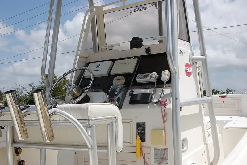 Slide: The Image of 1992 Mako 221 Center Console boat dashboard with steering wheel and navigation equipment. - 7