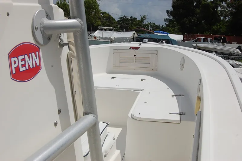 Slide: The Image of 1992 Mako 221 Center Console boat with Penn logo, docked outdoors. - 8