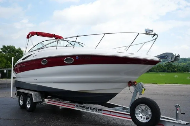 Slide: The Image of 2008 Crownline 250 CR boat on trailer, red and white design, parked outdoors. - 3