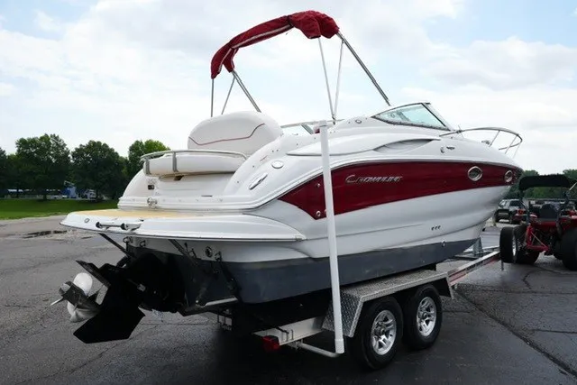Slide: The Image of 2008 Crownline 250 CR boat on trailer, red and white design, parked outdoors. - 5