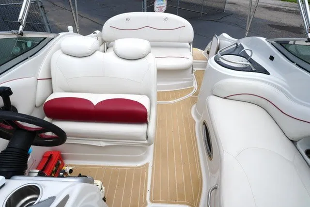 Slide: The Image of 2008 Crownline 250 CR boat interior with white and red seating, wooden flooring. - 12