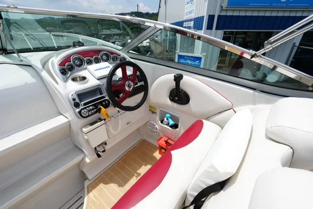 Slide: The Image of 2008 Crownline 250 CR boat cockpit with red accents and modern dashboard controls. - 10