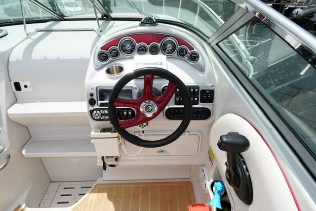 Slide: The Image of 2008 Crownline 250 CR boat dashboard with steering wheel and control panel. - 11