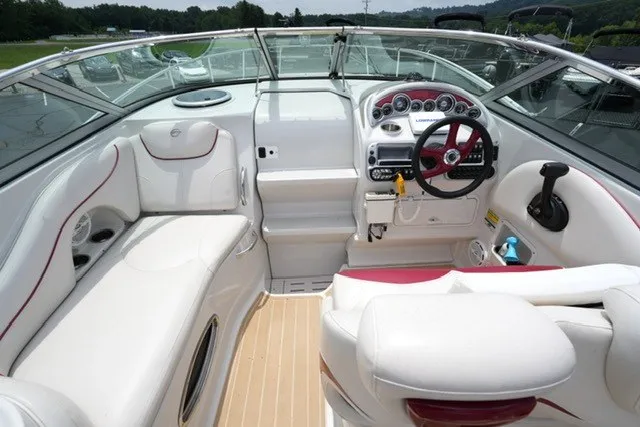 Slide: The Image of 2008 Crownline 250 CR boat interior with white seating and modern dashboard controls. - 9
