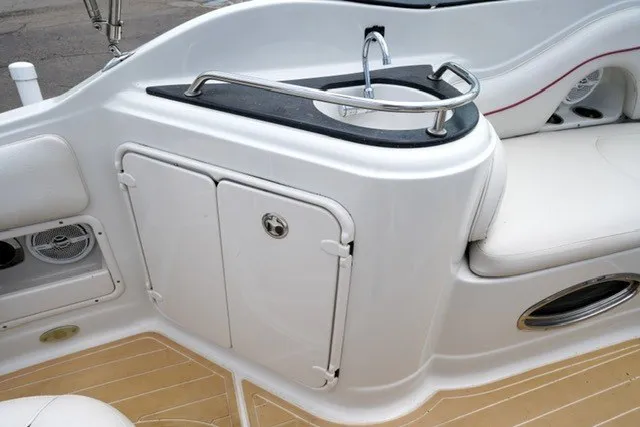 Slide: The Image of 2008 Crownline 250 CR boat interior with sink and storage compartments. - 13