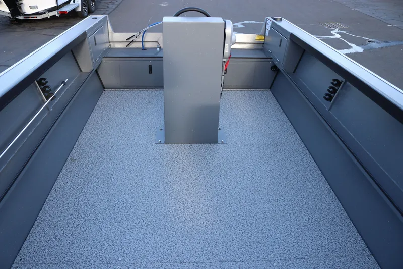 Slide: The Image of 2027 Alumaweld Adventurer 20 boat interior with gray textured flooring and central console. - 10