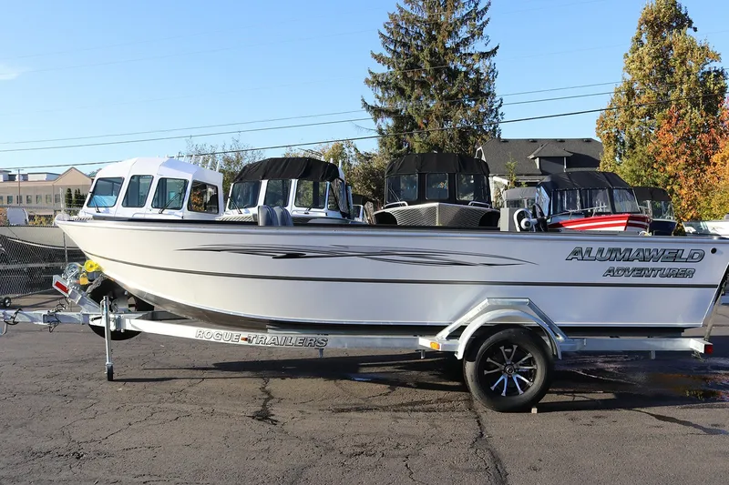 Slide: The Image of A 2027 Alumaweld Adventurer 20 boat sits on a trailer in a parking lot. - 10