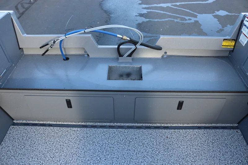 Slide: The Image of Interior view of 2027 Alumaweld Adventurer 20 boat with storage compartments and hose setup. - 12