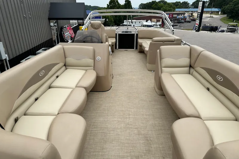 Slide: The Image of 2016 Harris Cruiser 240 pontoon boat with beige seating and spacious deck layout. - 5