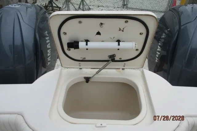 Slide: The Image of Open storage compartment on 2000 Grady-White F-26 Tigercat boat with Yamaha engines. - 21