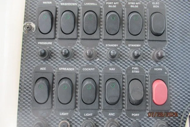 Slide: The Image of Control panel of a 2000 Grady-White F-26 Tigercat boat with various switches. - 11