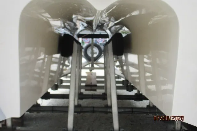 Slide: The Image of Underneath view of a 2000 Grady-White F-26 Tigercat boat on a trailer. - 14