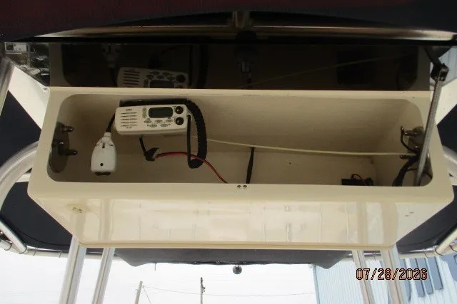 Slide: The Image of Storage compartment with radio equipment on a 2000 Grady-White F-26 Tigercat boat. - 6
