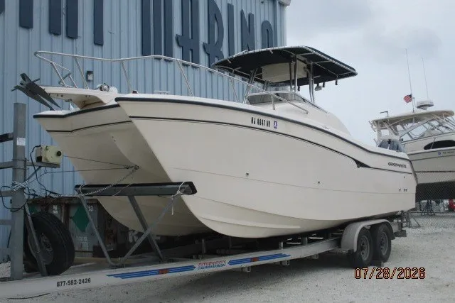 Slide: The Image of 2000 Grady-White F-26 Tigercat boat on trailer, parked near marina. - 18