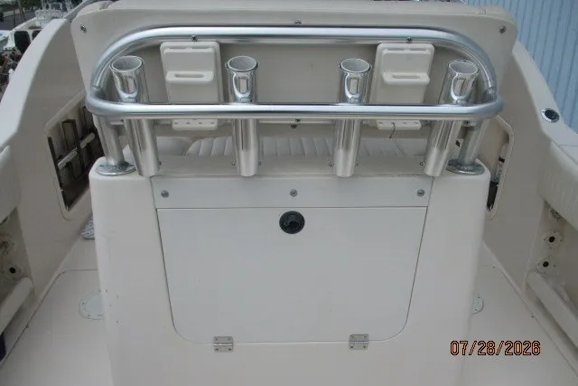 Slide: The Image of 2000 Grady-White F-26 Tigercat boat with rod holders and storage compartment. - 25