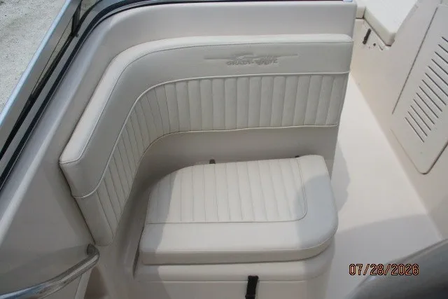 Slide: The Image of White cushioned seating on a 2000 Grady-White F-26 Tigercat boat interior. - 32
