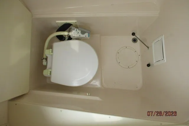 Slide: The Image of Boat bathroom interior of 2000 Grady-White F-26 Tigercat, featuring a compact toilet. - 40